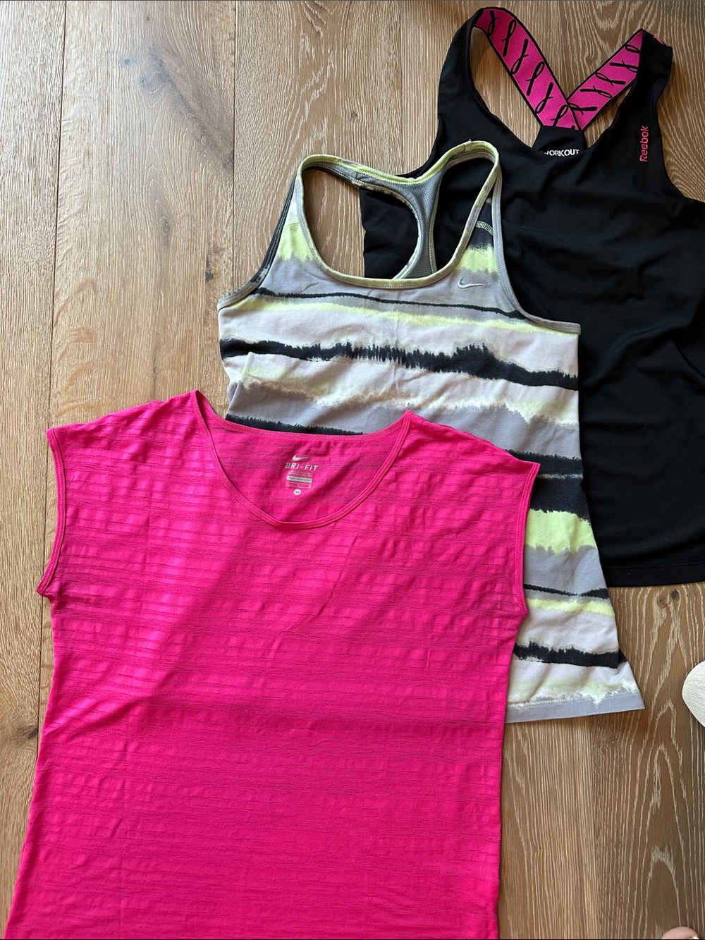 Set of 3 Nike and Reebok workout tops. Women’s M/L